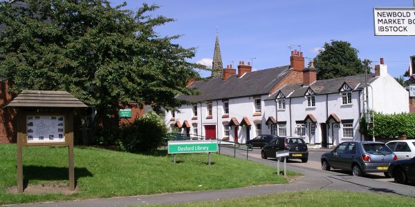 A picture of the village green looking towards the library on a sunny day